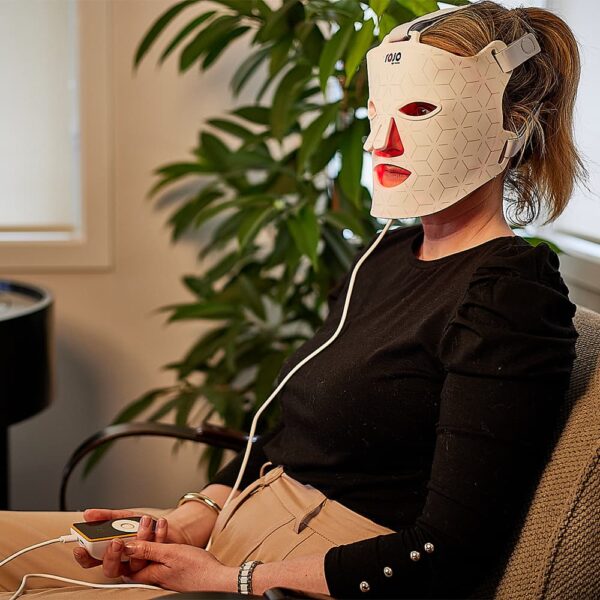 rojo led facial mask being used at home