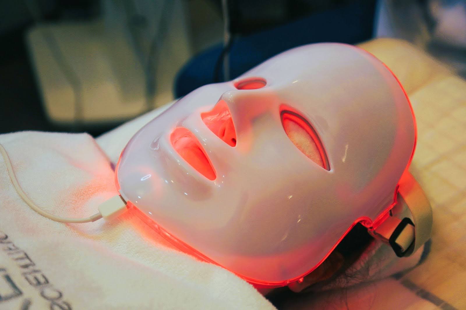 Person demonstrates how a red light therapy mask works.